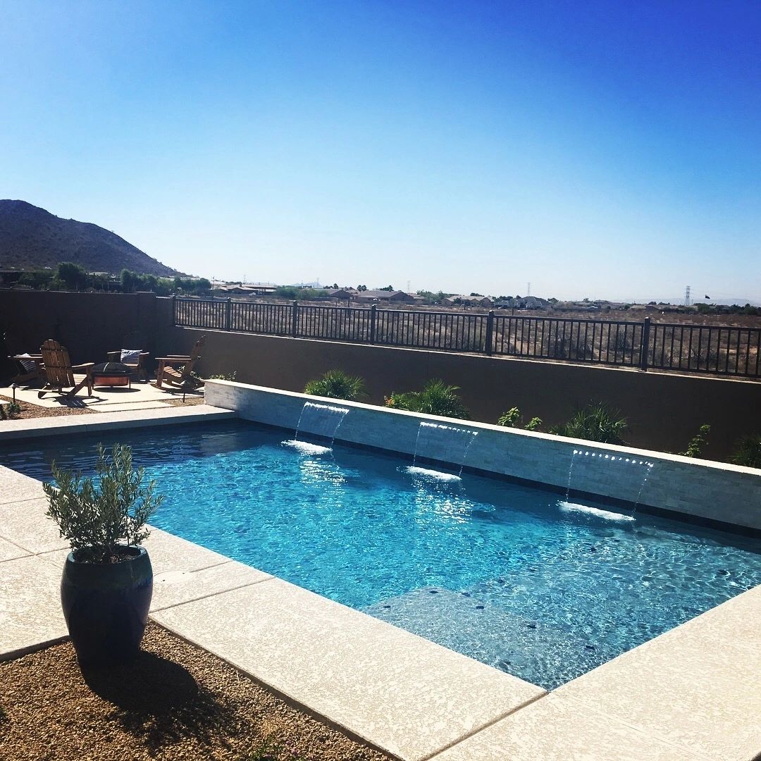 A pool with a view of the mountains and a sky background