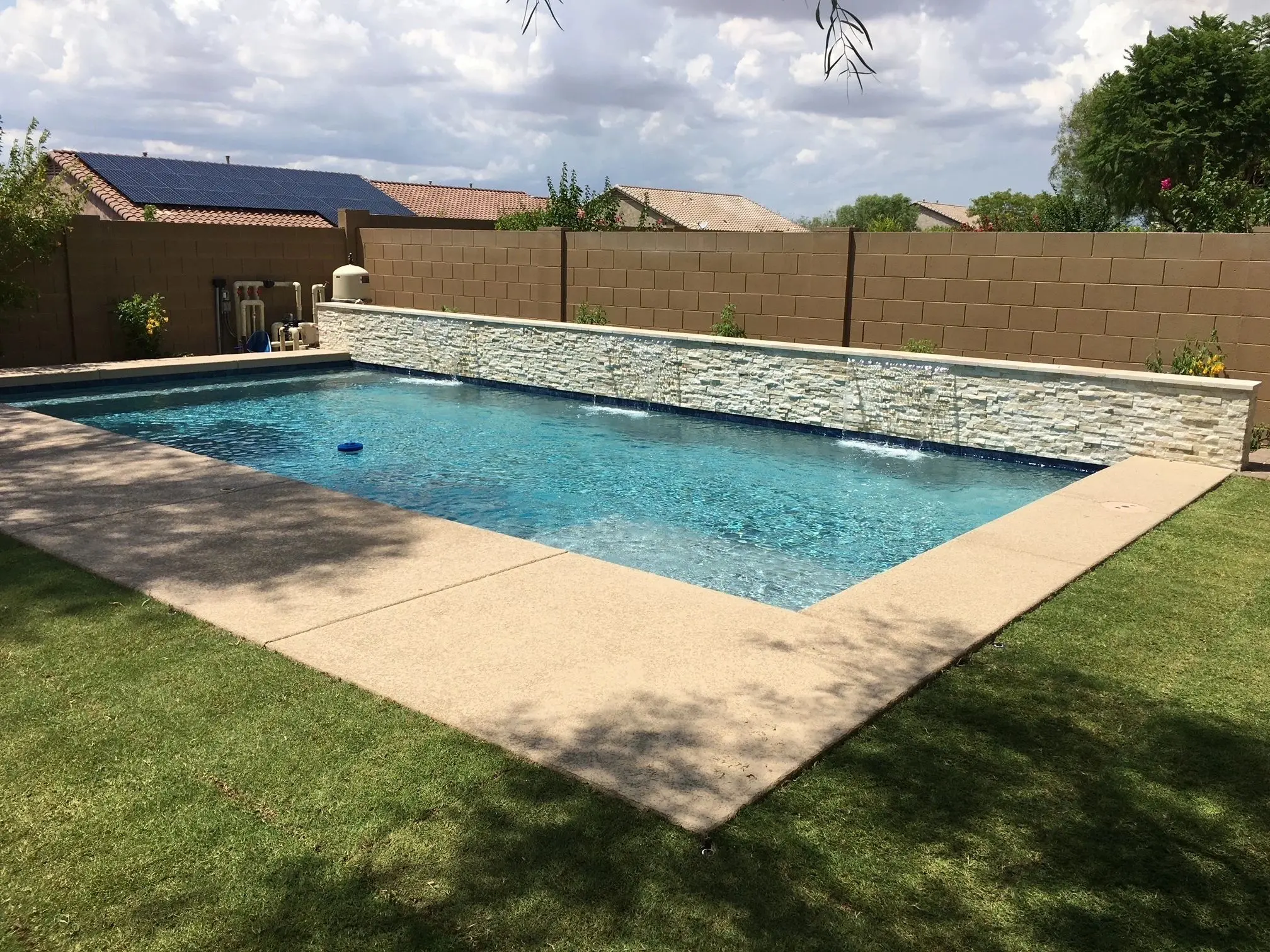 A pool that is in the middle of some grass.