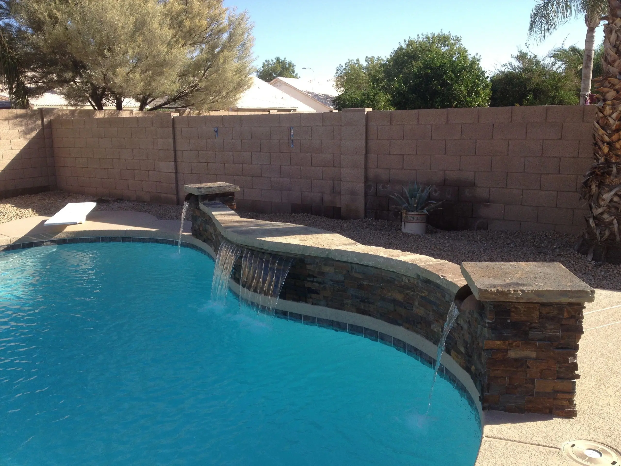 A pool with water falling into it.