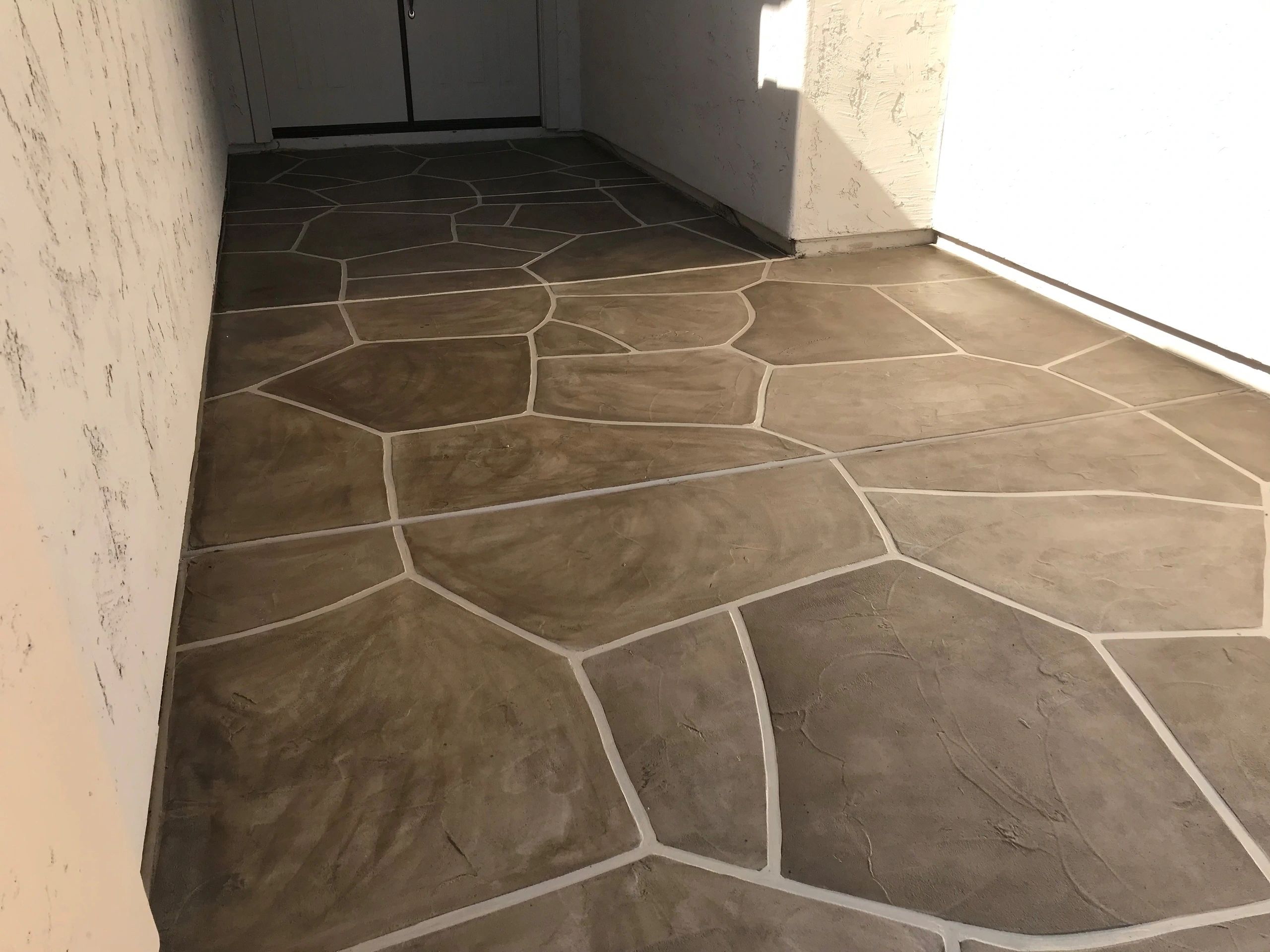 A floor with a pattern of brown and white lines.