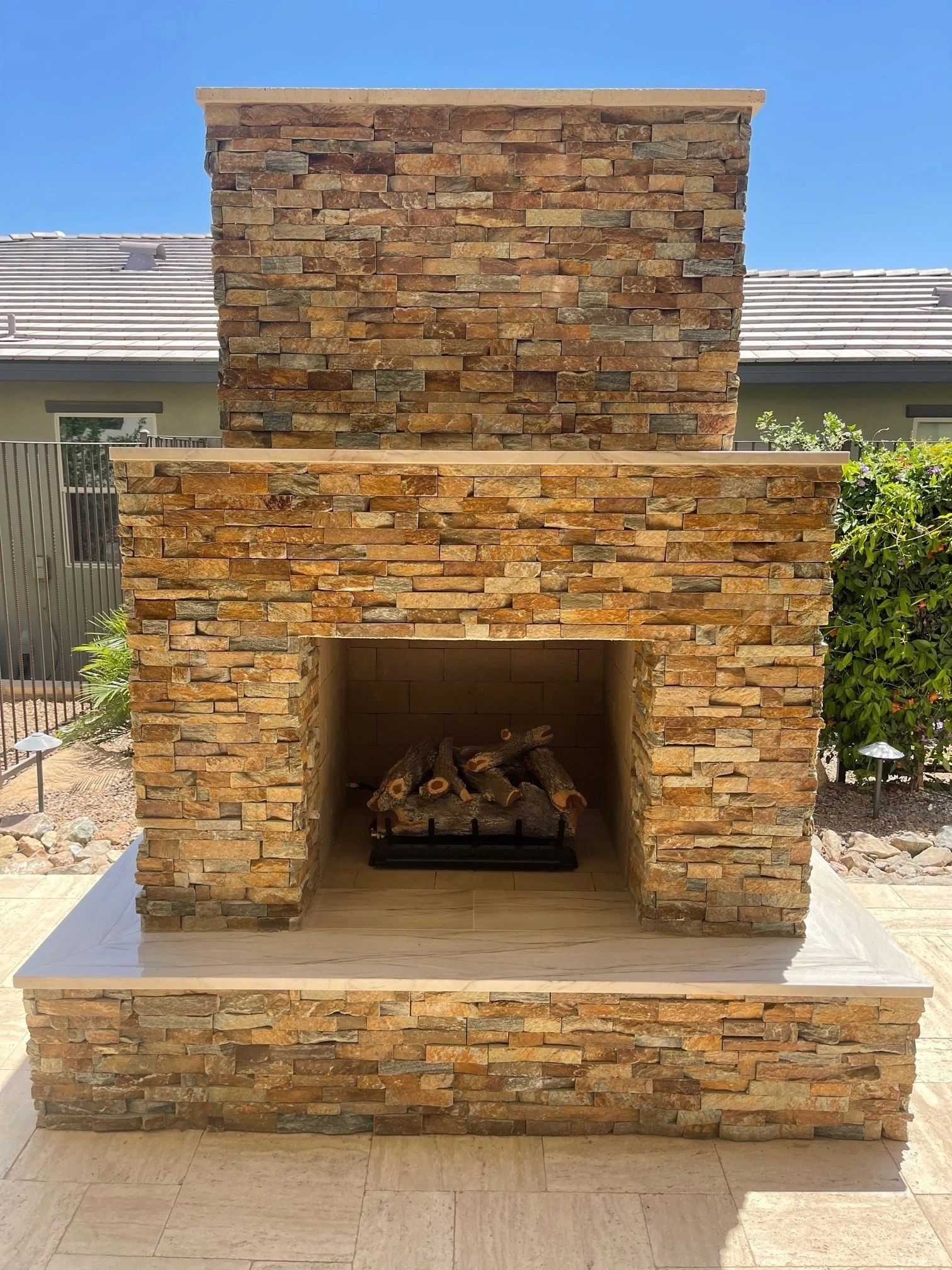 A fireplace with stone and wood on the outside.