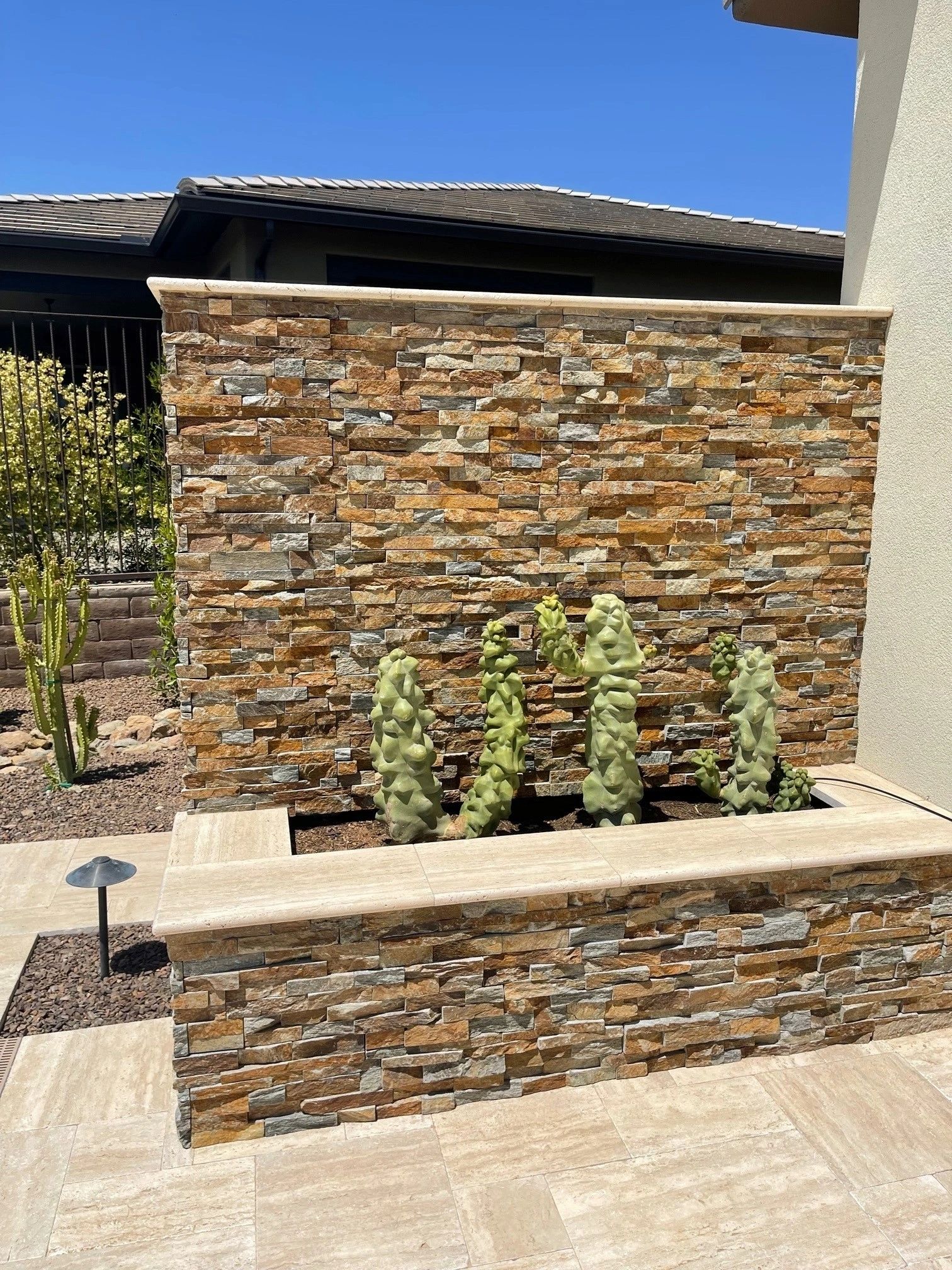 A stone wall with plants in it