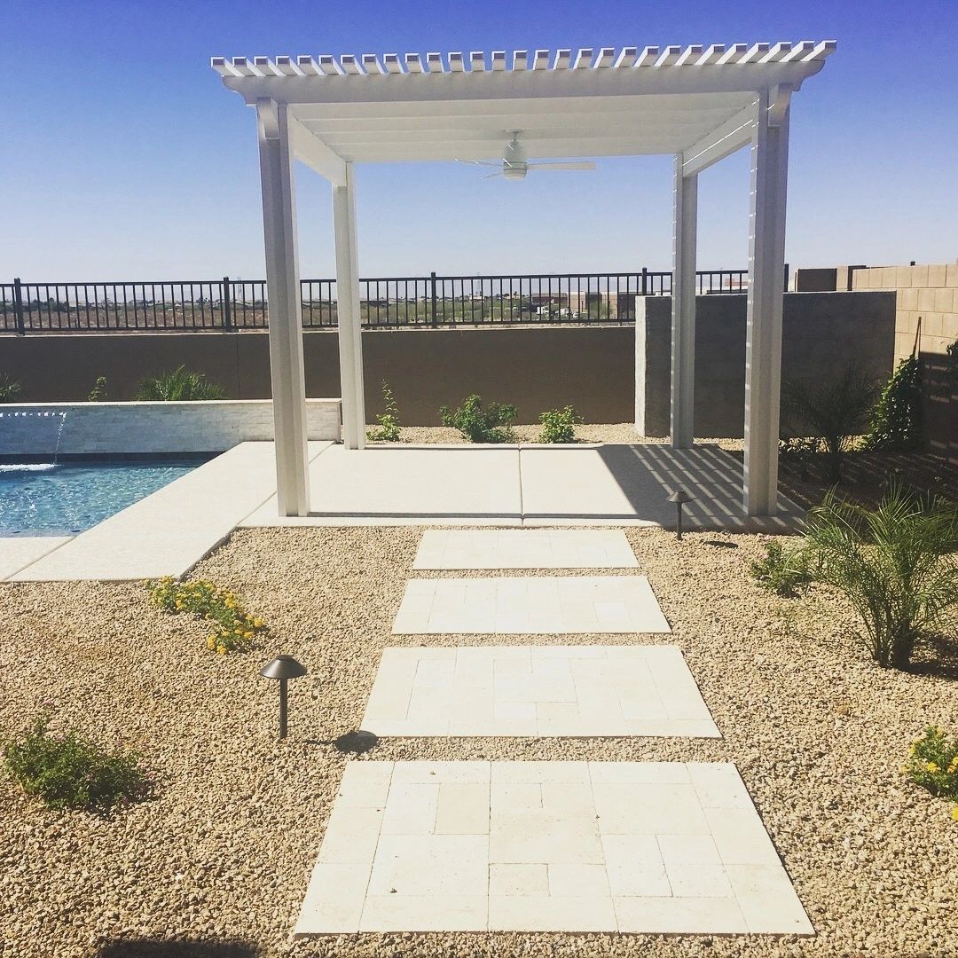 A white pergola near the pool with a walkway.