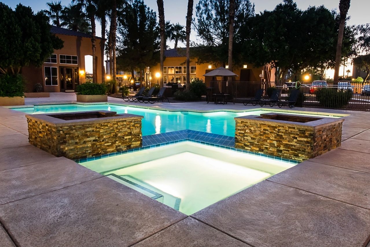 A pool with lights on in the middle of it.