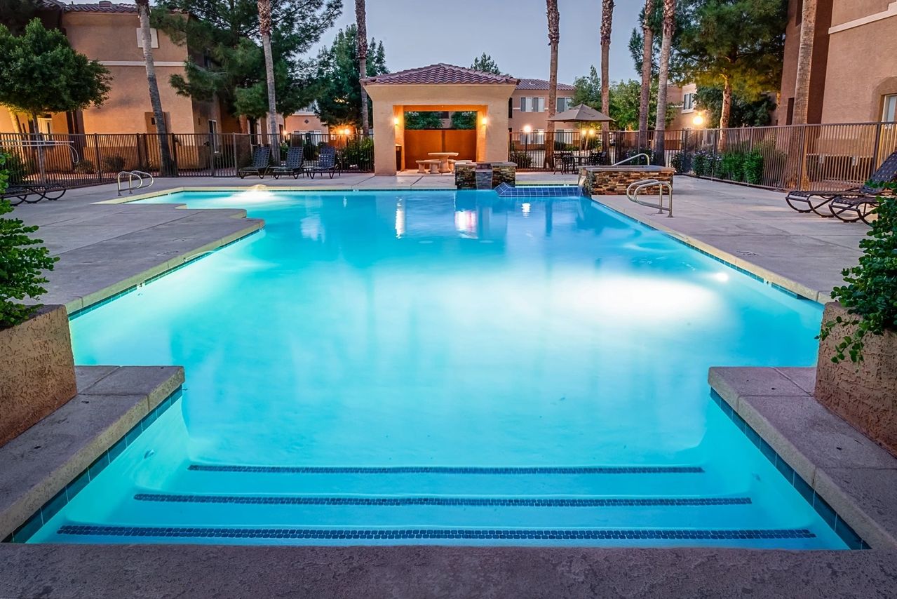 A pool with steps leading to the side of it.